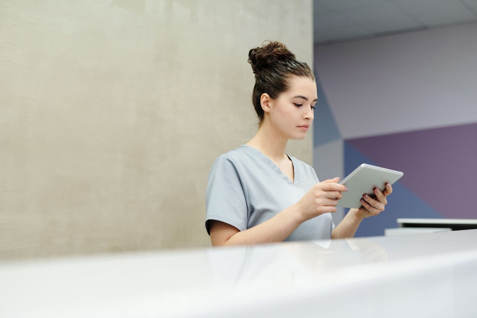 A front-desk team member checking details on a tablet