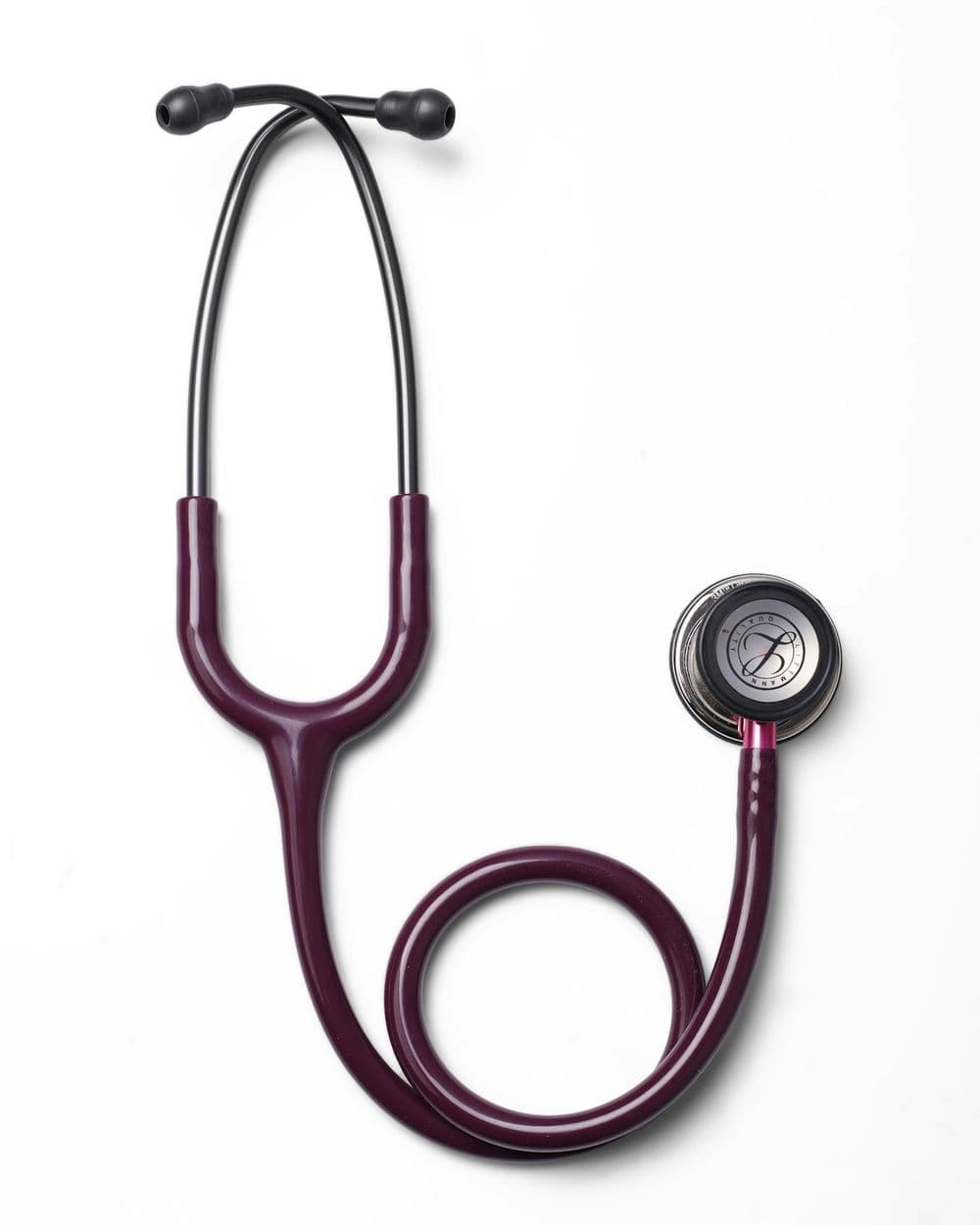 A burgundy stethoscope resting on a white surface