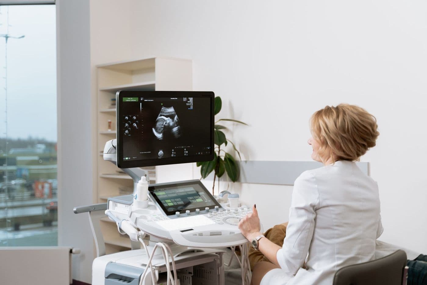 A clinician reviewing an ultrasound image on screen